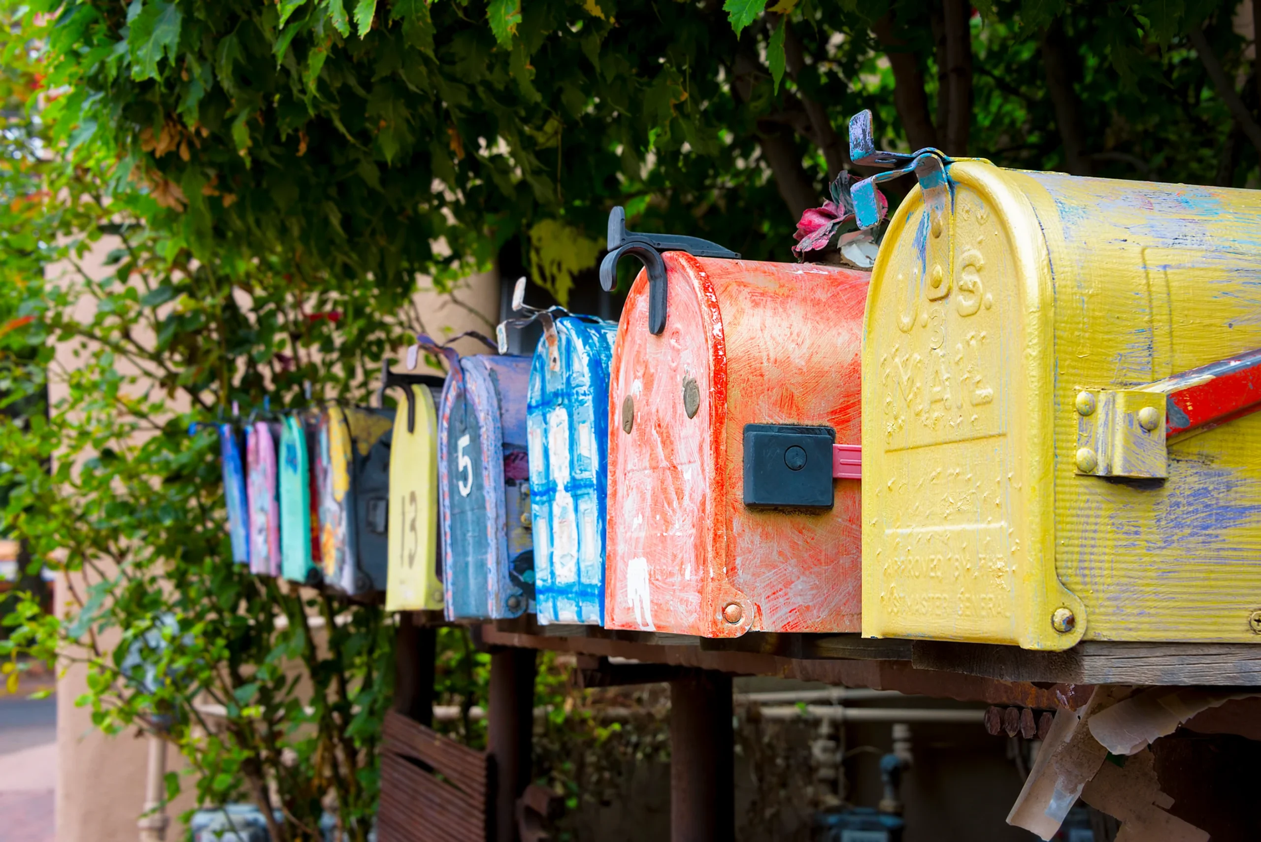 a row of multi-colored mailboxes